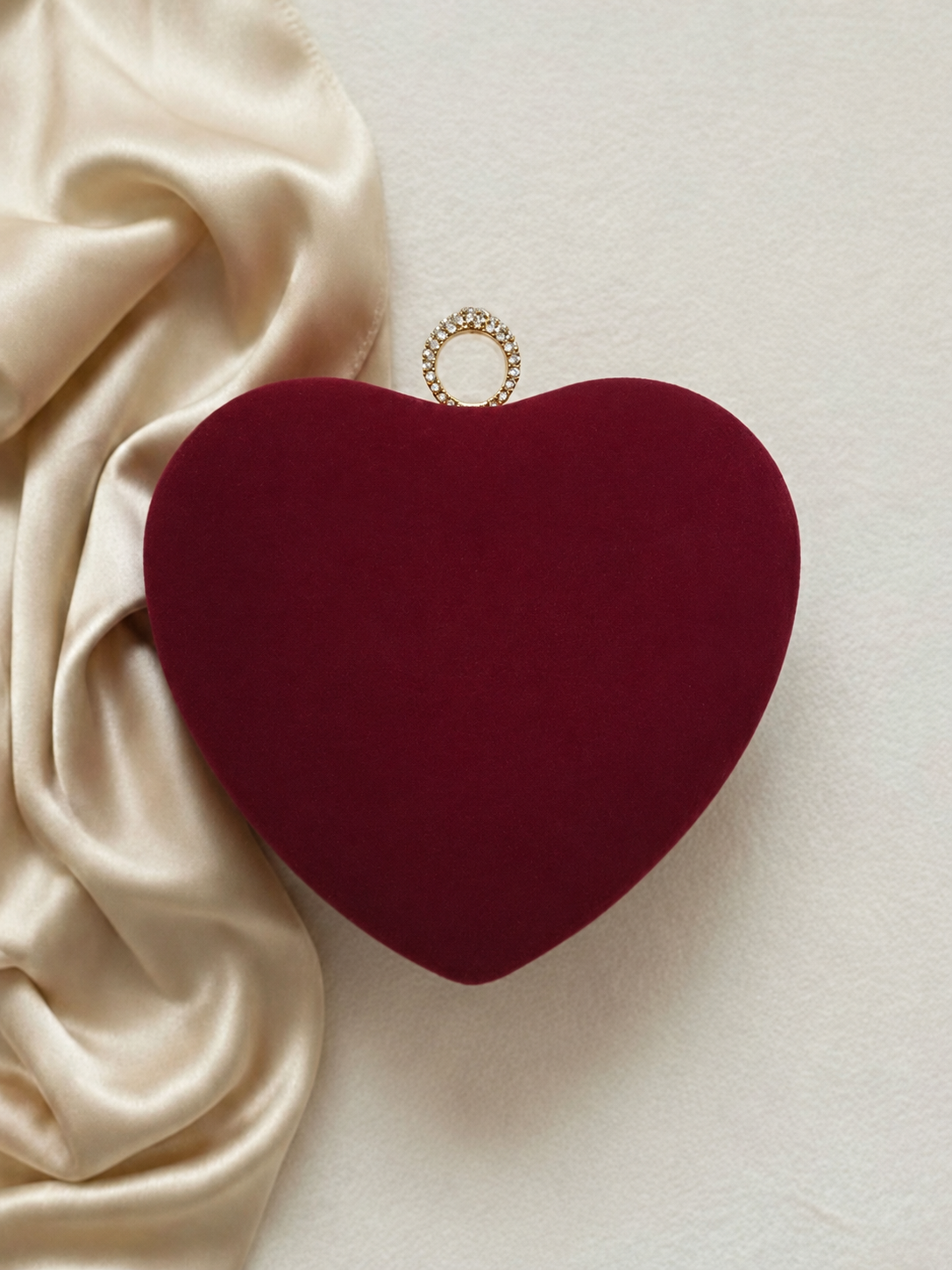 Maroon velvet heart-shaped clutch without name or initial