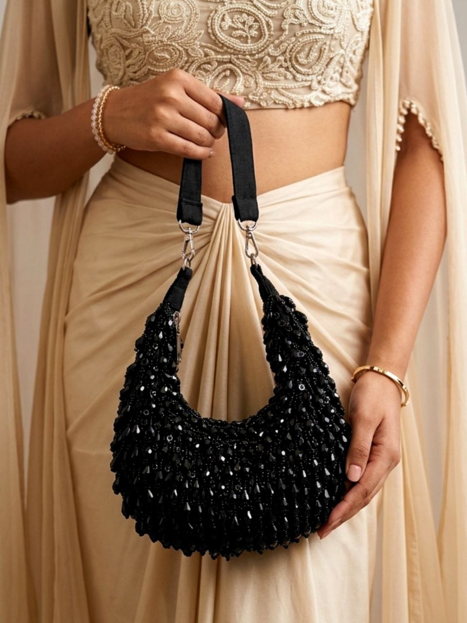 Aabha black pearl beaded crescent clutch styled with handle