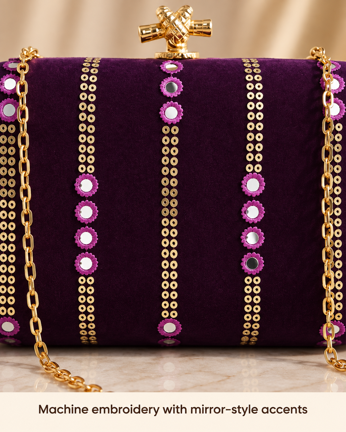 Purple machine embroidery with mirror-style accents close-up