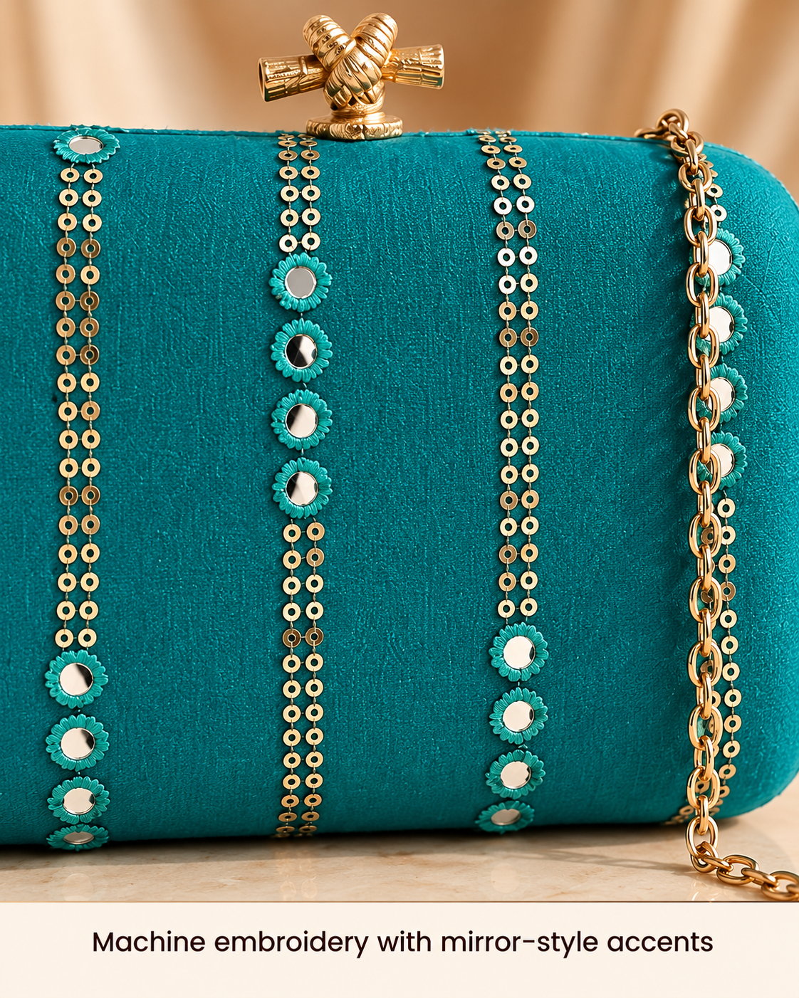 Teal machine embroidery with mirror-style accents close-up