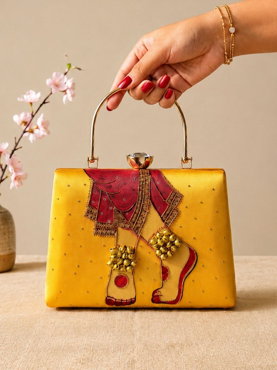 Phera mustard hand-embroidered bridal print clutch with gold metal handle