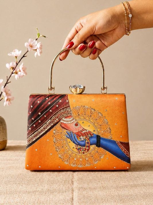 Riwaayat orange hand-embroidered bridal print clutch with gold metal handle