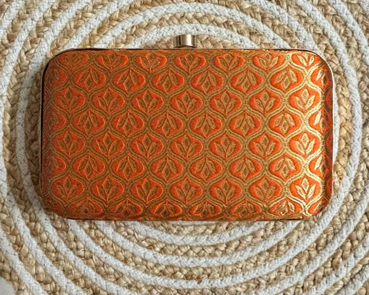 The Rust Edit orange and gold brocade box clutch front view