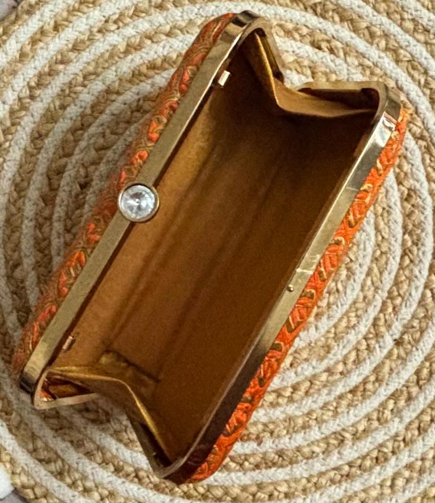 The Rust Edit clutch interior and gold frame detail