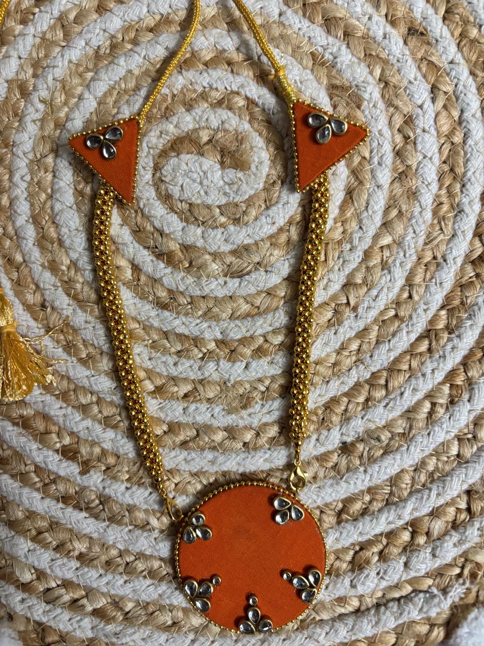 The Rust Edit orange fabric necklace with interchangeable round pendant